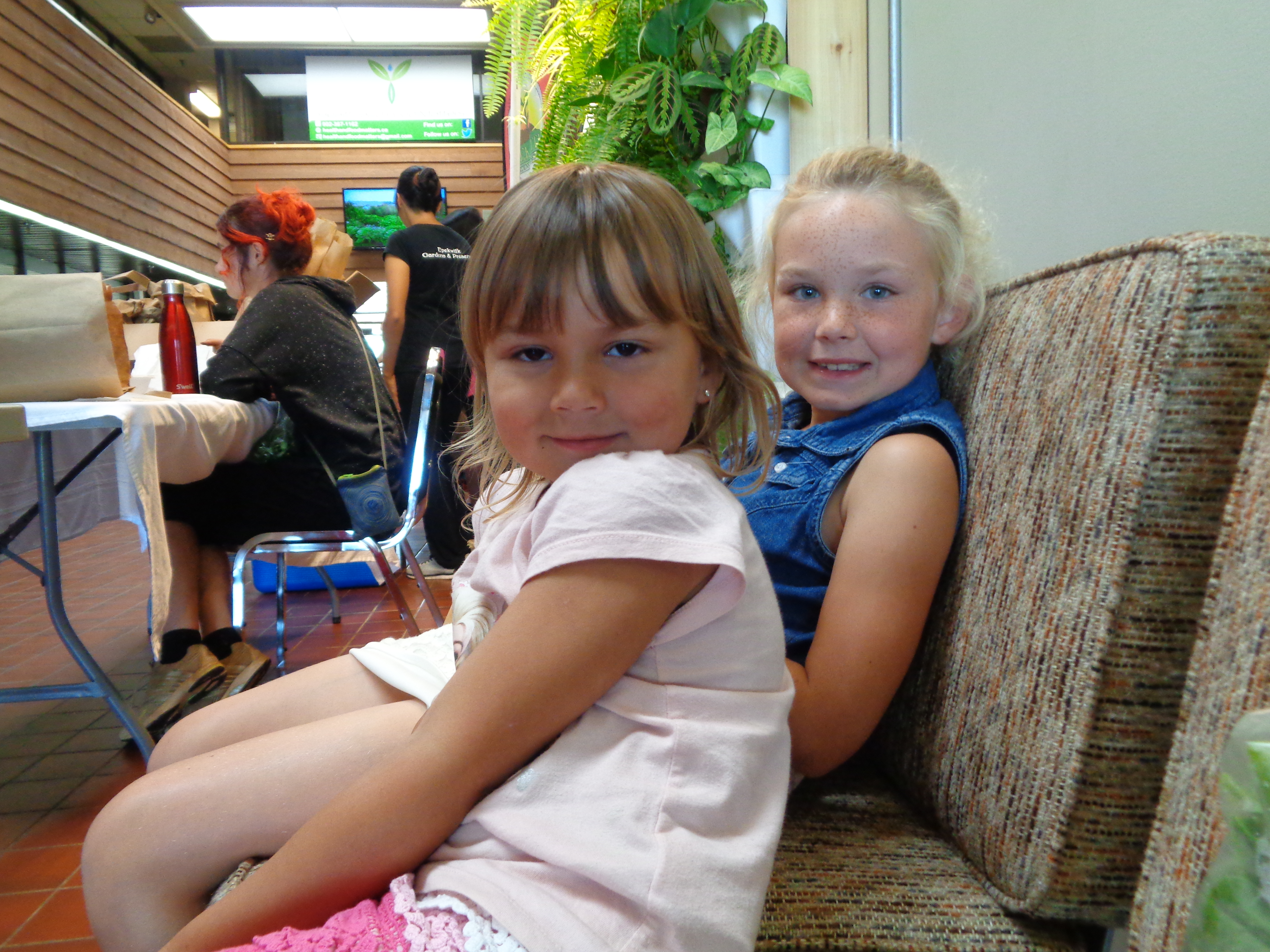 two little girls sitting on a couch